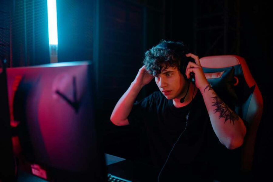 a man wearing headphones in front of a computer