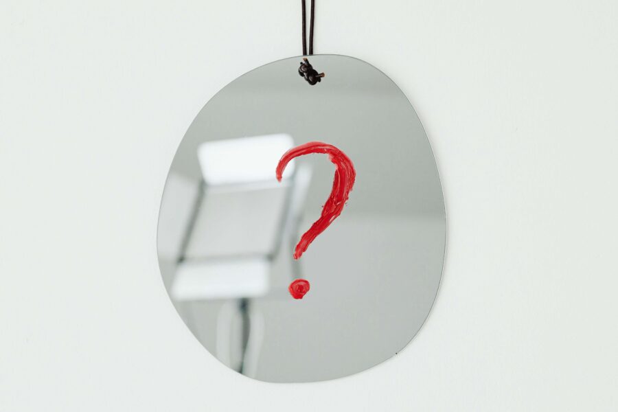 a red question mark on a mirror