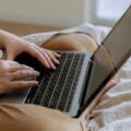 a man with a laptop in bed