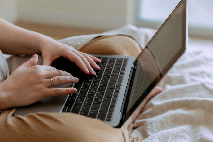 a man with a laptop in bed