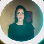 Woman standing in front of a ring light