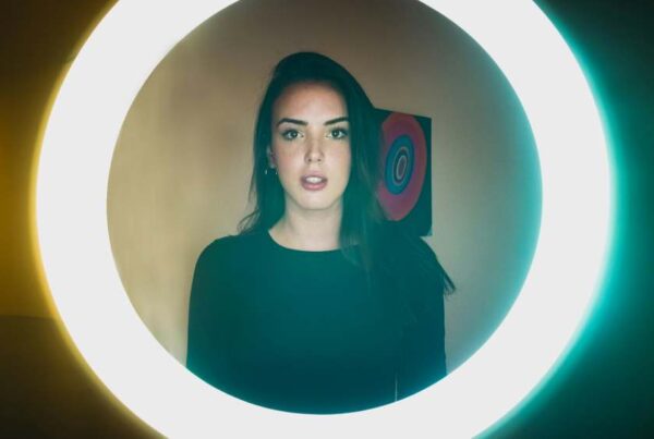 Woman standing in front of a ring light