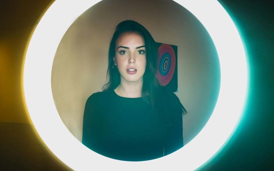 Woman standing in front of a ring light