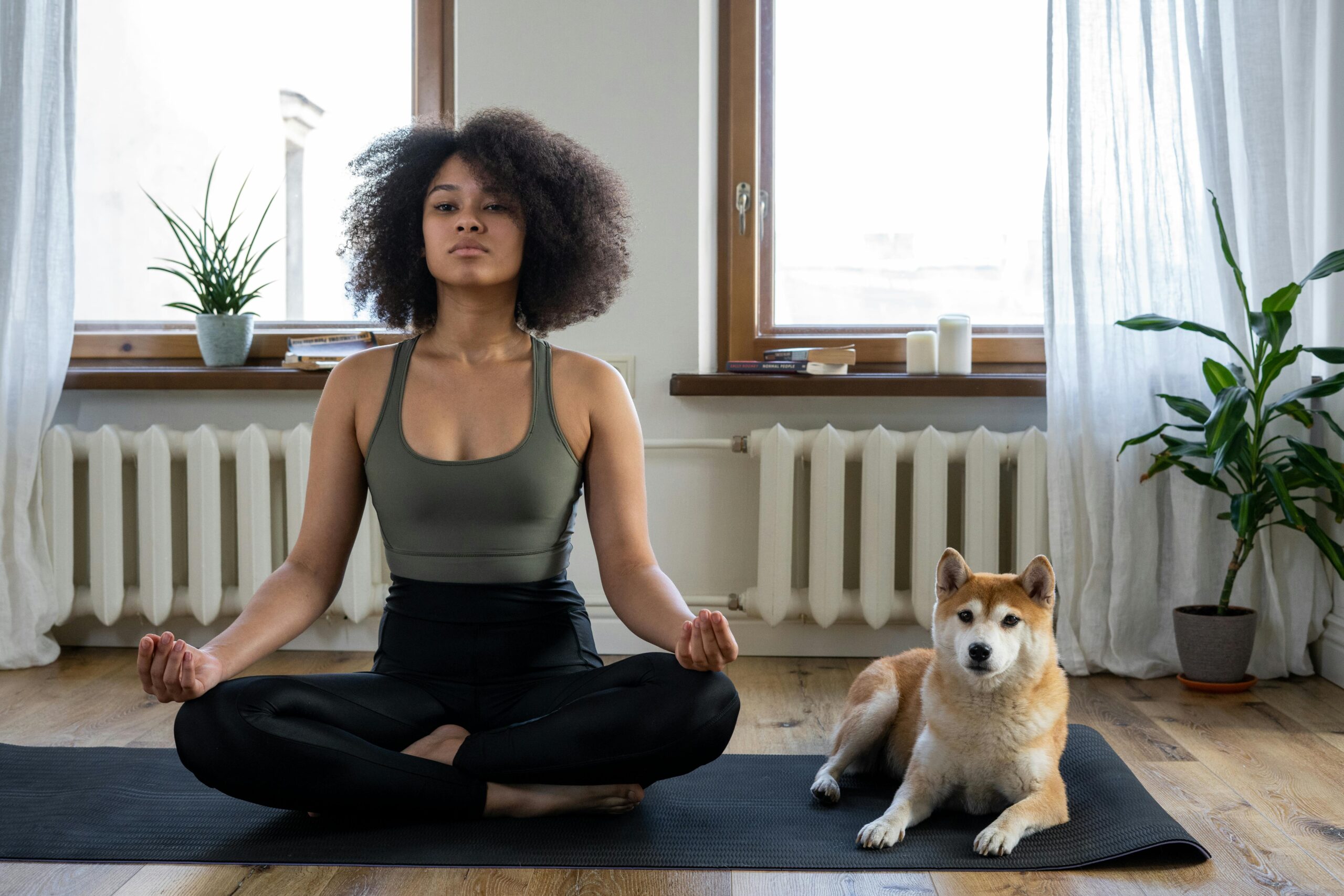 a woman meditating on a yoga mat