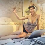 a woman in her underwear filming herself on her phone