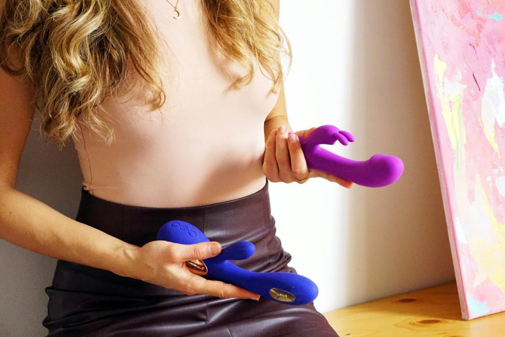 A woman holding sex toys